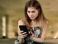 young woman looking at something on her cell phone