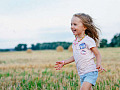 a joyful young child running through a field